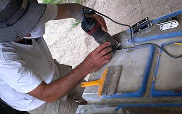 Cutting away fiberglass for the hinges (upper right) to sit in