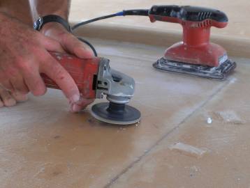 Grinding off epoxy bumps, then sanding the entire bimini top