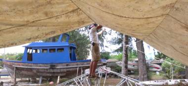 Jon balanced precariously, adjusting the lines for our awning