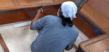 Lek brushing another coat of epoxy onto some of the salon teak