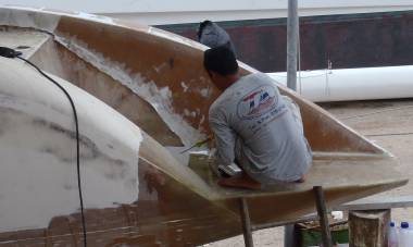 Lek epoxying the first layer of fiberglass onto our starboard wall