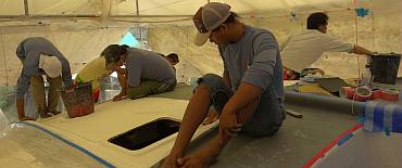 The team sanding and preparing the cabin-top for gelcoat