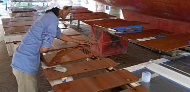 Lek sanding the cabinet doors, preparing them for more varnish