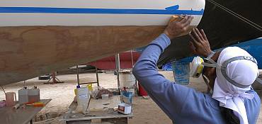 Lek sanding the gelcoat under the taped paint-line