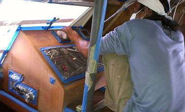 Lek perched on the nav-desk while he sanded and painted