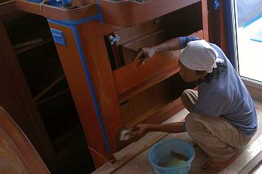 Lek sanding under the nav-desk for another coat of epoxy