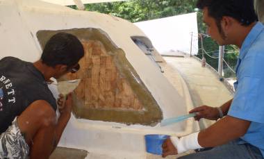 Max & Boy fiberglassing the bare balsa in the cockpit