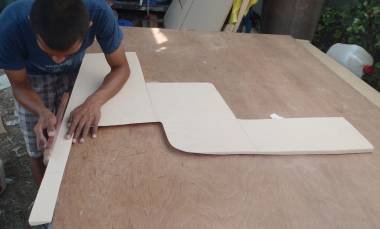 Max shaping a complicated bit of foam for our entryway