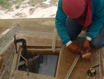 Mee fitting small gutter sections around the hatch opening