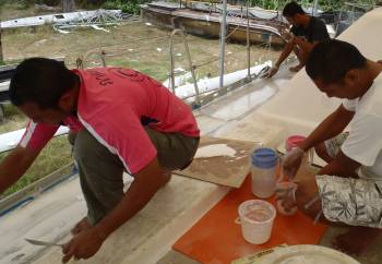 E-U, Max, & Golf lay epoxy mud on the port side-deck