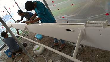 Pla, Baw, and Ben preparing the boom for a 2nd coat