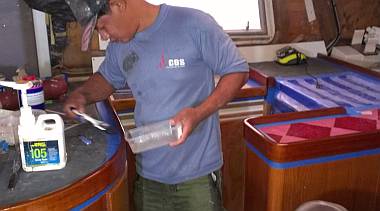 Pla brushing a 3rd layer of epoxy on high wear areas of the galley