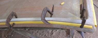 Clamping half-pipe bolt-rope tracks on before super-gluing them