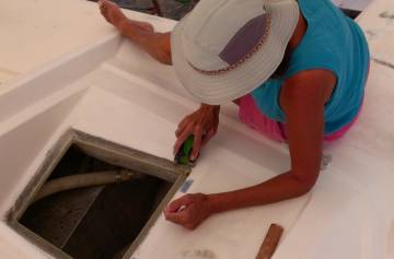 Sue sanding out defects in the starboard filler