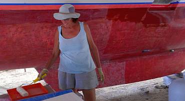 Sue rolling today's first layer of epoxy on the port hull