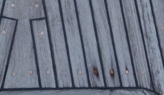 Tired teak decks, with screws up & worn down wood