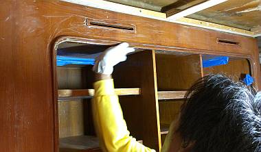 Yando sanding varnish in the port aft cabin