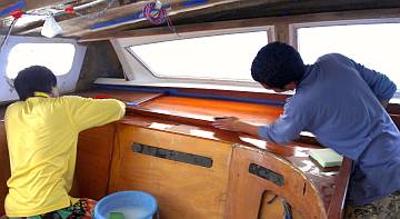 Yando and Ben sanding the epoxy on a big salon shelf