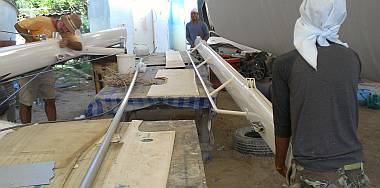 Jon installs sheaves while the men get the boom ready to work on