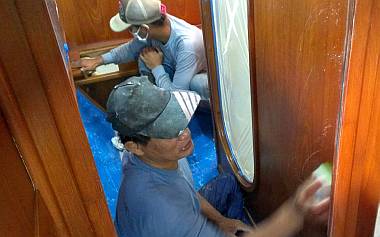 Heru and Pla sanding yesterday's spray inside the port aft cabin
