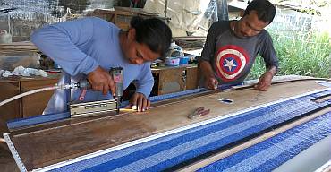 Stapling the mounting "ears" onto the long salon headliners